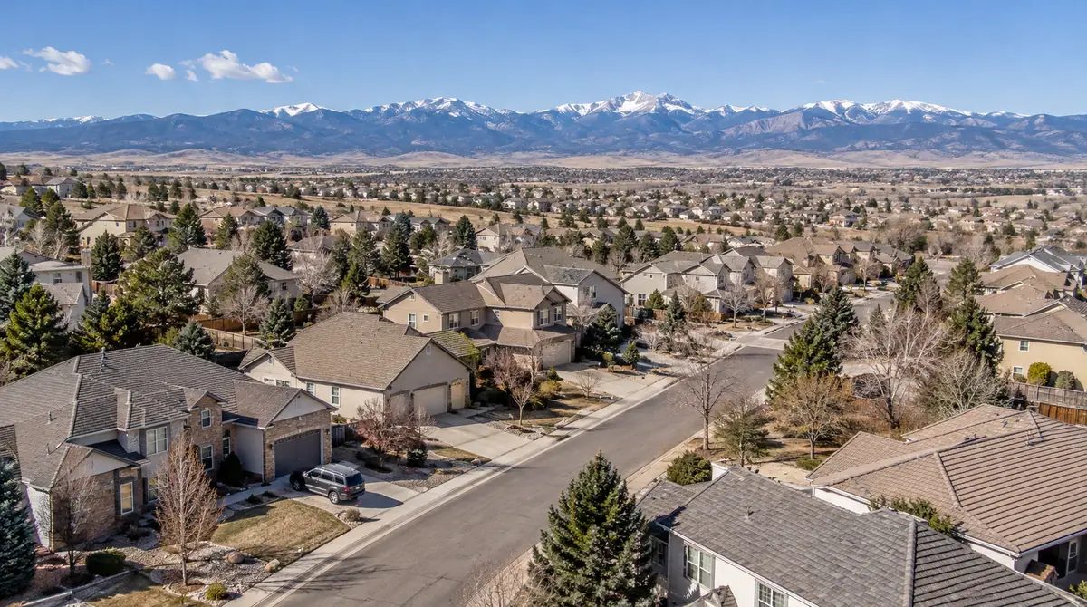 Aerial view of a residential neighborhood with mountains on the horizon