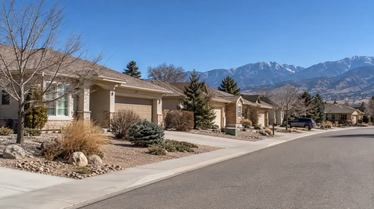 Street of single-family homes with mountains in the distance